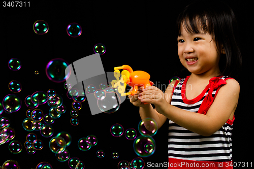 Image of Asian Chinese Little Girl Playing Soap Bubbles