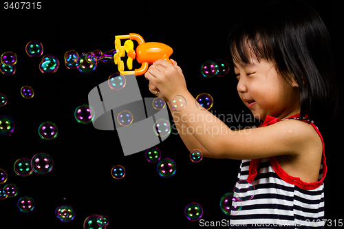 Image of Asian Chinese Little Girl Playing Soap Bubbles