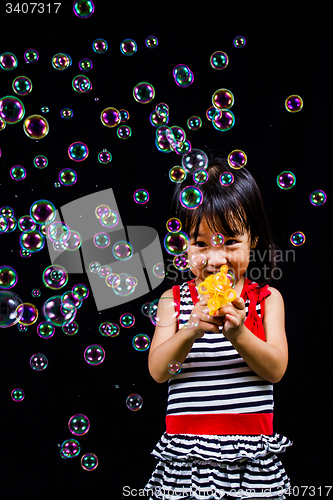 Image of Asian Chinese Little Girl Playing Soap Bubbles