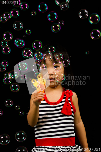 Image of Asian Chinese Little Girl Playing Soap Bubbles