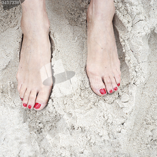 Image of woman feet on the sand