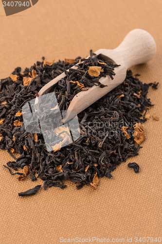 Image of Black Dry Tea with a Wooden Spoon