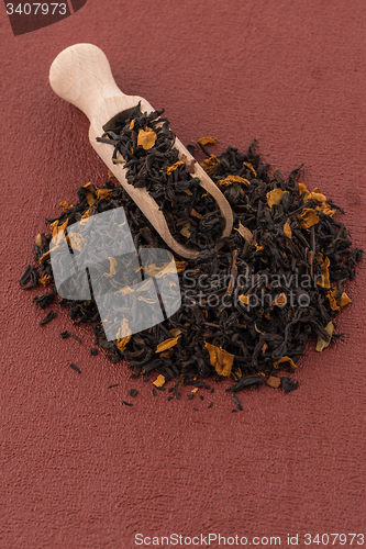 Image of Black Dry Tea with a Wooden Spoon