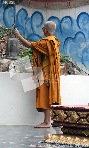 Image of monk ringing the bell