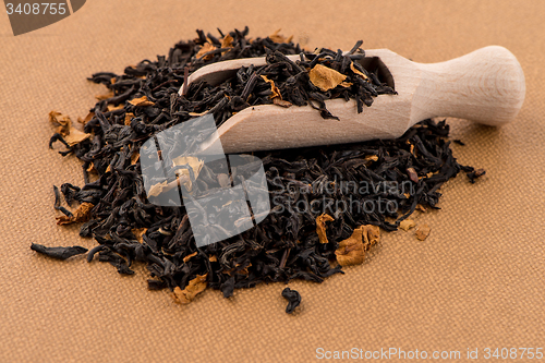 Image of Black Dry Tea with a Wooden Spoon