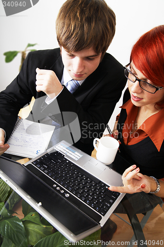 Image of beautiful caucasian business woman with young consultant