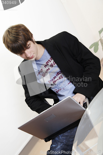 Image of confident young manager at work with laptop