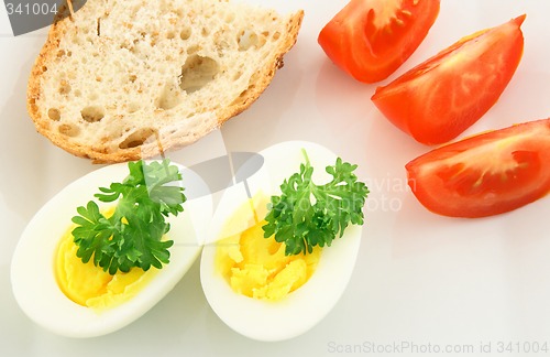 Image of Simple meal. Eggs, bread and tomatos.