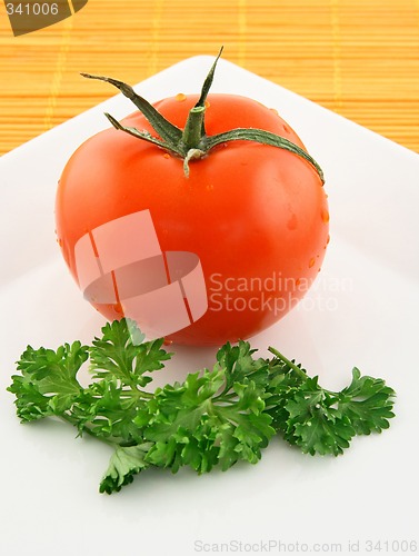 Image of Fresh tomato and parsley on a plate