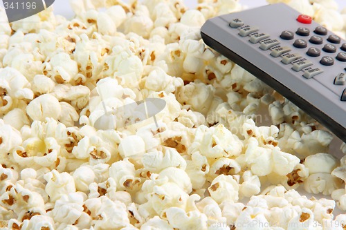 Image of popcorn and remote control detail