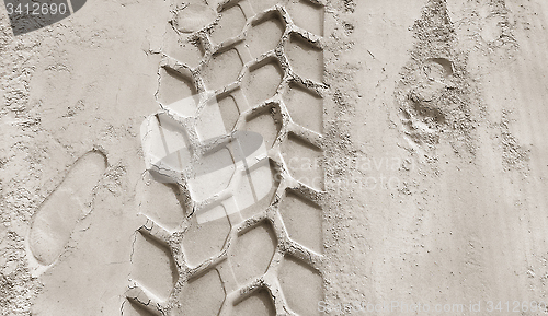 Image of Wheel track and footprints on the sand