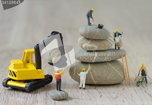 Image of Pebbles stack and figurines workers