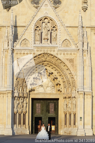 Image of Newlyweds standing in front of Cathedral