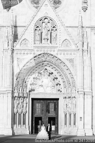 Image of Newlyweds standing in front of Cathedral black and white