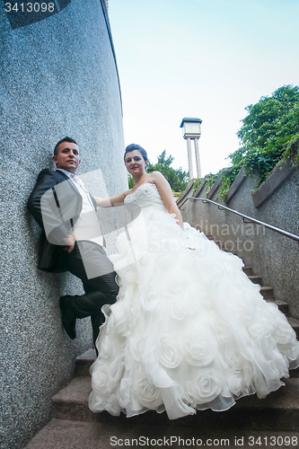 Image of Newlyweds posing on stone steps