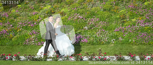 Image of Newlyweds walking on pathway