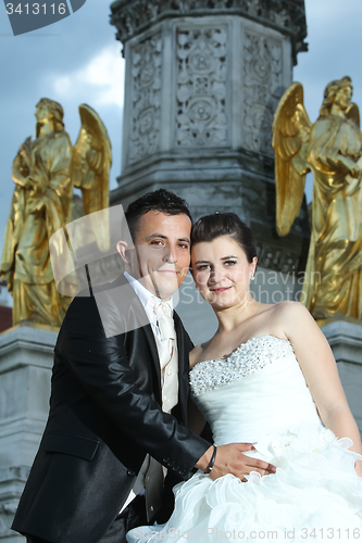 Image of Bride and groom in front of fountain