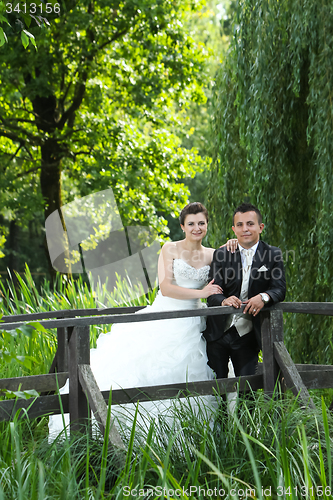 Image of Bride and groom posing in nature