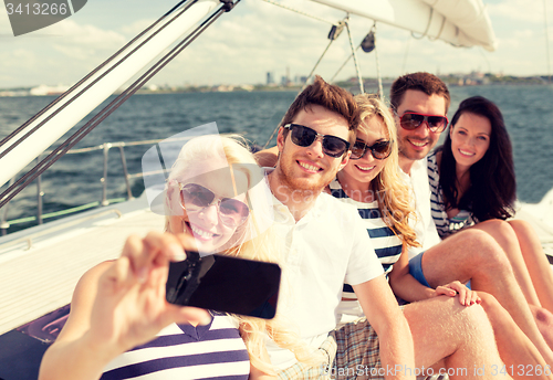 Image of smiling friends sitting on yacht deck