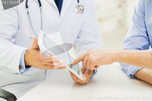 Image of close up of male doctor and patient with tablet pc