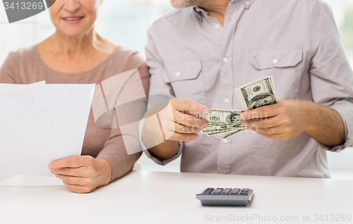 Image of close up of senior couple with money and bills