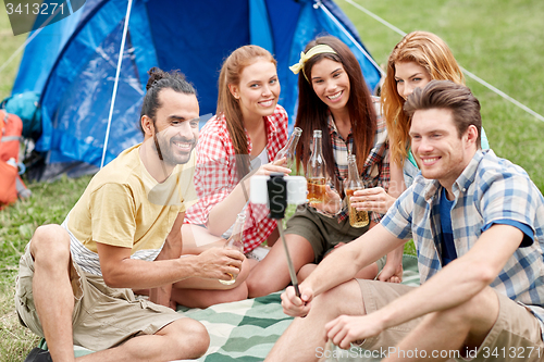 Image of happy friends taking selfie by smartphone at camp
