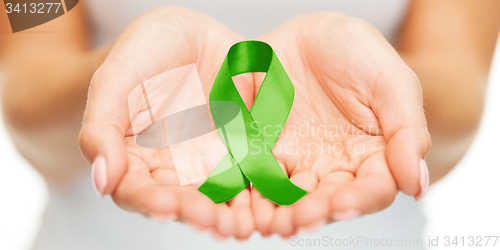 Image of hands holding green awareness ribbon