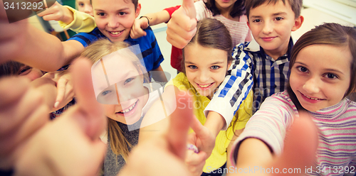 Image of group of school kids showing thumbs up