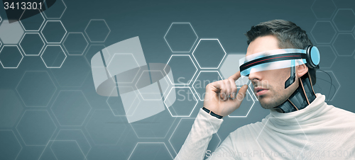 Image of man with futuristic 3d glasses and sensors