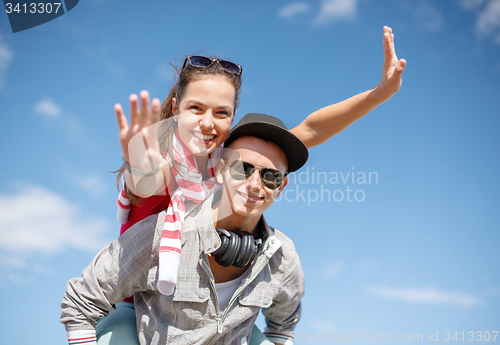 Image of smiling teenagers in sunglasses having fun outside