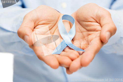 Image of hands with blue prostate cancer awareness ribbon