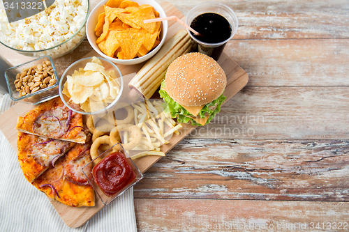 Image of close up of fast food snacks and drink on table