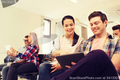 Image of group of smiling students with tablet pc