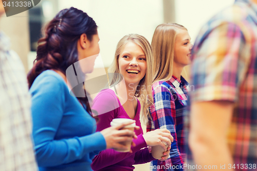 Image of group of smiling students with paper coffee cups
