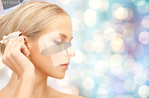 Image of beautiful woman with seashell