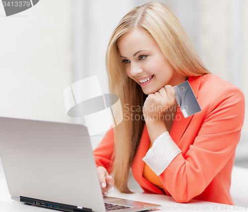 Image of businesswoman with laptop and credit card