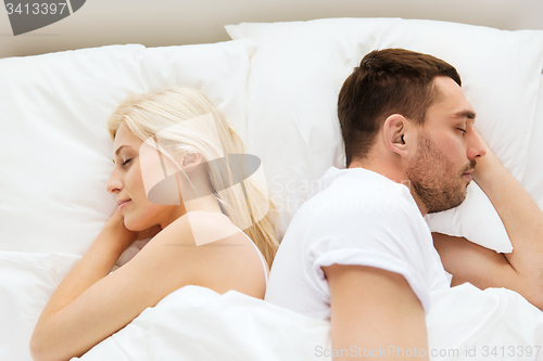 Image of couple sleeping in bed at home