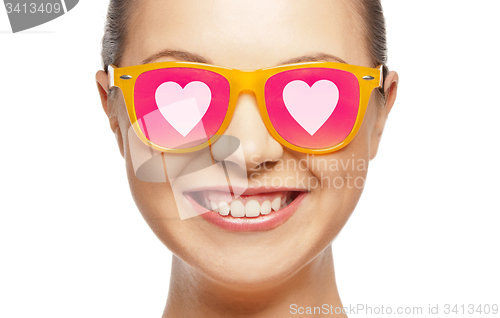 Image of smiling teenage girl in pink sunglasses