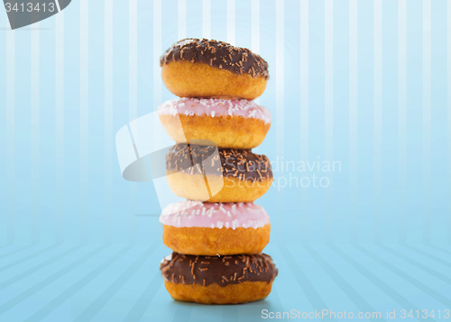 Image of close up of glazed donuts pile over blue