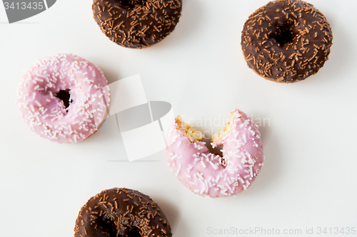 Image of close up of glazed donuts pile over white