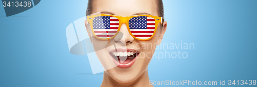 Image of happy teenage girl in glasses with american flag