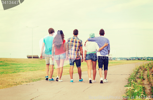 Image of group of teenagers walking outdoors from back