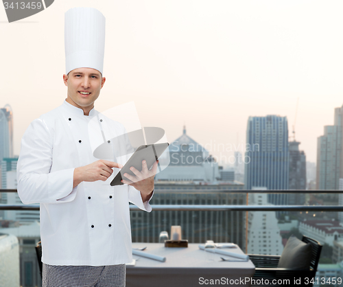 Image of happy male chef cook holding tablet pc
