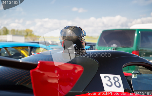 Image of close up of car with helmet on roof top