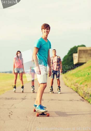 Image of group of smiling teenagers with roller-skates