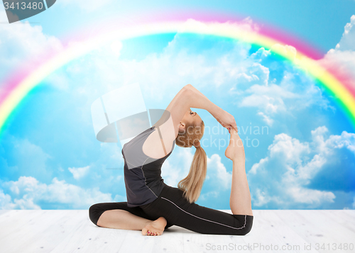 Image of happy young woman doing yoga exercise