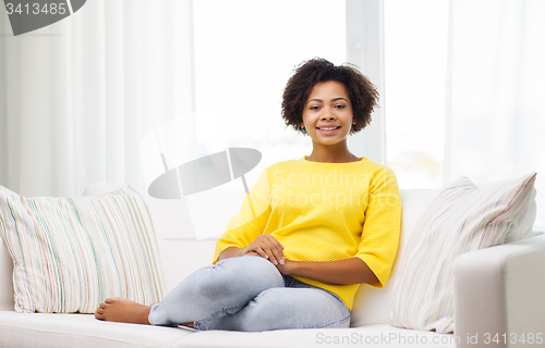 Image of happy african american young woman at home