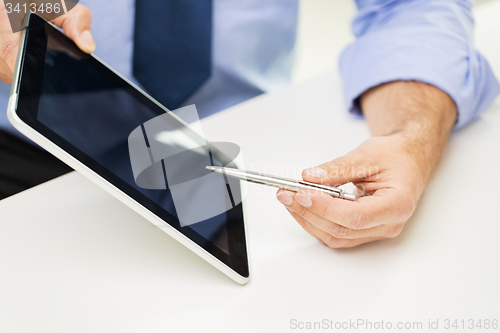 Image of close up of businessman hands with tablet pc