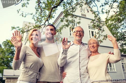 Image of happy family in front of house outdoors