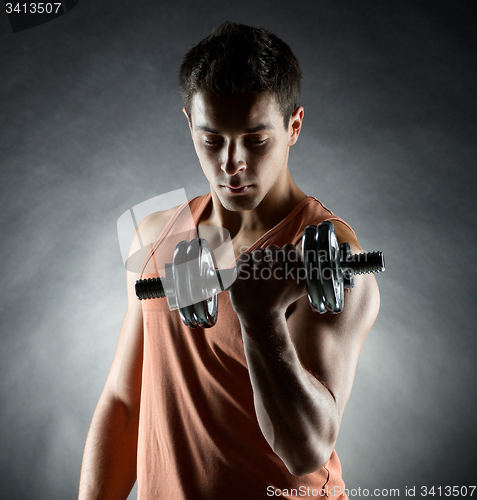 Image of young man with dumbbell